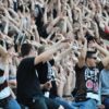 Fans in der Suedkurve feiern ihre Mannschaft